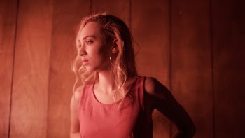 Woman Wearing Pink Sleeveless Tops Standing Near Brown Wooden Wall