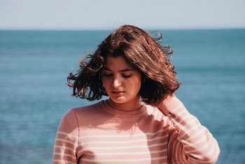 Woman Wearing Pink Striped Sweater