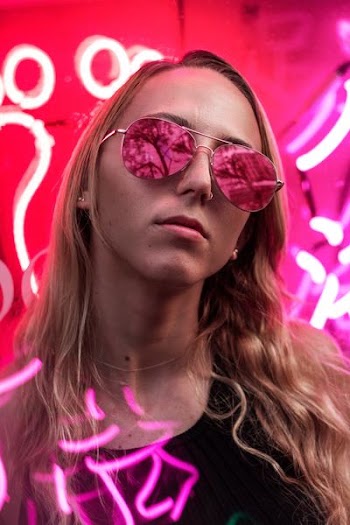 woman wearing pink sunglasses with silver frames