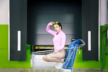 Woman Wearing Pink Swimsuit Riding Grocery Cart