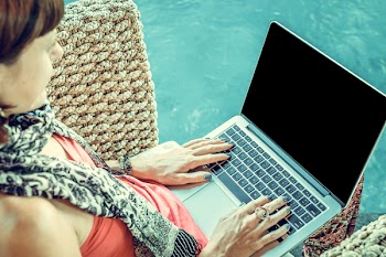 Woman Wearing Pink Top With Macbook on Lap