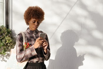 Woman Wearing Plaid Shirt And Looking At Her Phone