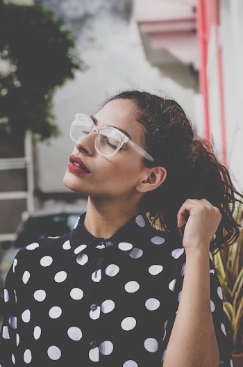 Woman Wearing Polkadots Shirt And Eyeglasses
