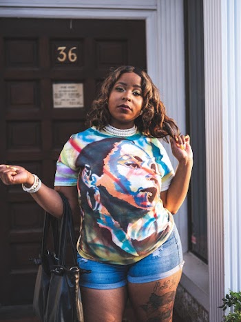 Woman Wearing Portrait Shirt and Blue Denim Shorts
