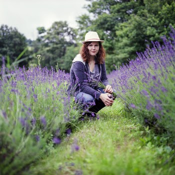 Woman Wearing Purple Jacket in Brown Hat during Day Time