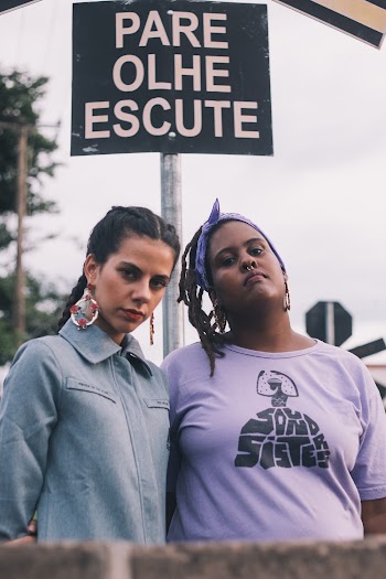 Woman Wearing Purple Scoop-neck Top Beside Woman Wearing Blue Denim Collared Top
