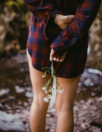 Woman Wearing Red and Blue Flannel Dress Shirt Holding White Flowers