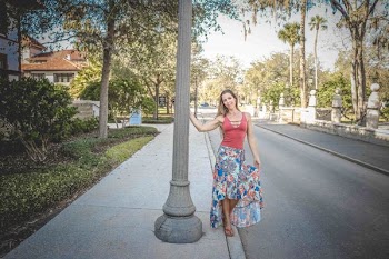 Woman Wearing Red and Blue Floral Tank Dress Beside Concrete Road