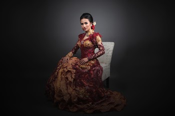 Woman Wearing Red and Brown Floral Maxi Gown