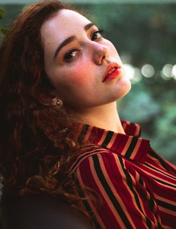 Woman Wearing Red and Brown Stripe Dress