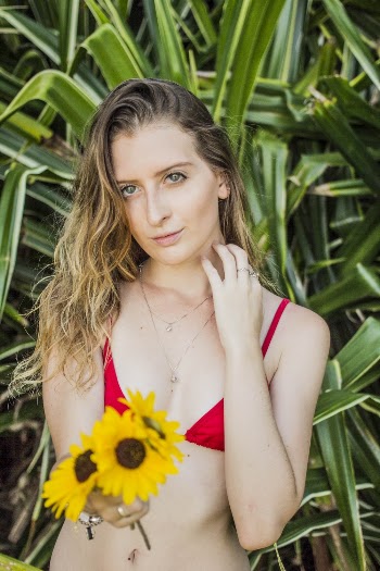 Woman Wearing Red Bikini Top Holding Flowers