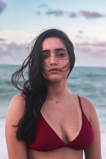 Woman Wearing Red Bikini Top Standing Near Body of Water