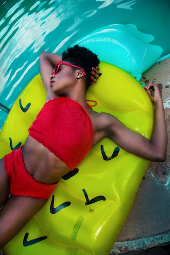 Woman Wearing Red Bikini Top With Pantie Laying on Inflatable Bed
