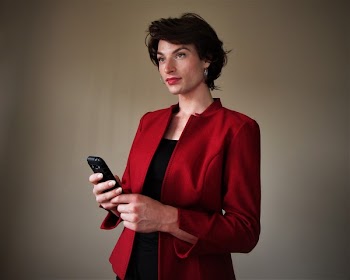 Woman Wearing Red Blazer Holding Smartphone