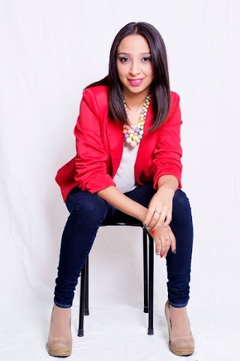 Woman Wearing Red Blazer Sitting on Black Stool