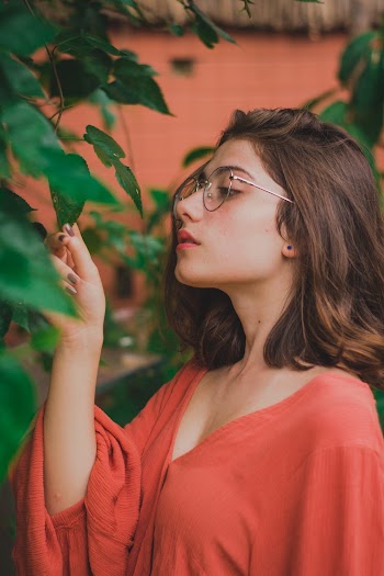 Woman Wearing Red Blouse Touching Green Leafed Tree