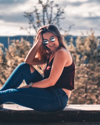 Woman Wearing Red Camisole and Blue Denim Jeans Outdoors