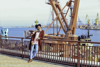 Woman Wearing Red Coat and Blue-washed Jeans
