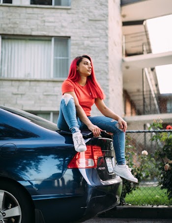Woman Wearing Red Crew-neck Shirt and Blue Faded Jeans
