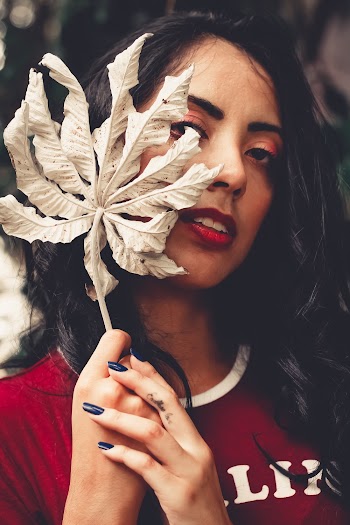 Woman Wearing Red Crew-neck Top Holding Brown Leaf