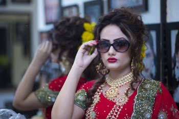 Woman Wearing Red Dress Holding Her Black Framed Sunglasses