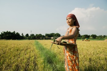 Woman Wearing Red Dress Holding Winnowing Basket With Vegetables