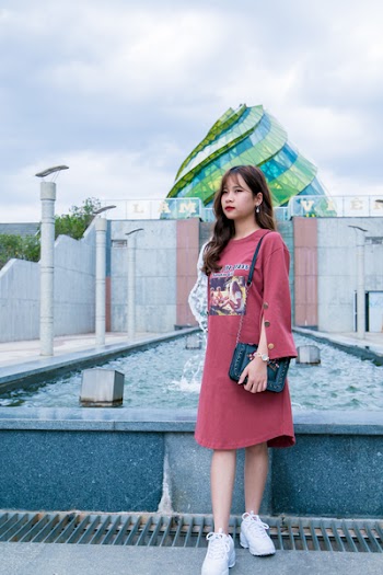 Woman Wearing Red Dress Standing Near Fountain