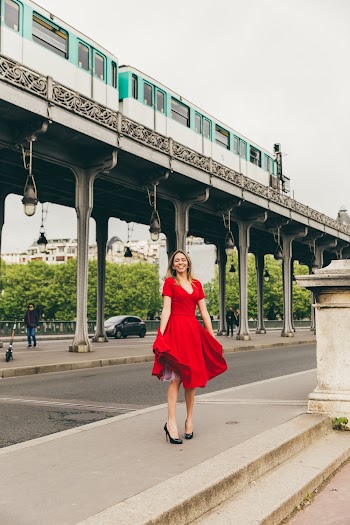Woman Wearing Red Dress Standing on Concrete Pavement