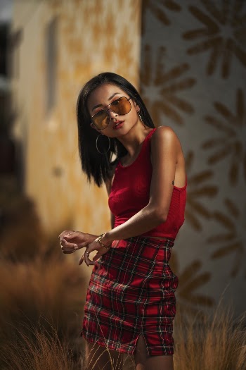 Woman Wearing red Halter Top and Checkered Skirt