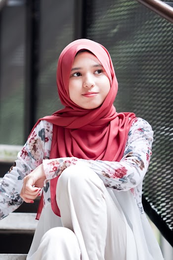 Woman Wearing Red Hijab Sitting on Stairs