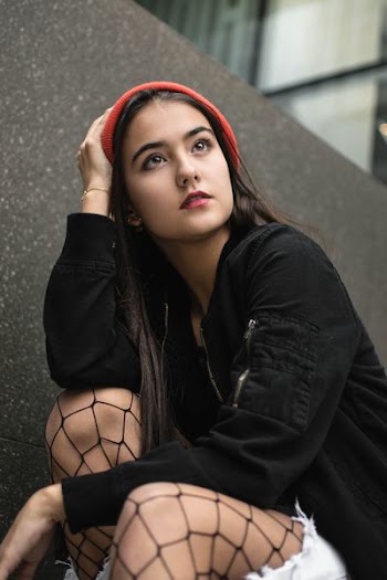 woman wearing red knit cap and black jacket