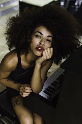 Woman Wearing Red Lipstick Sitting Near Piano