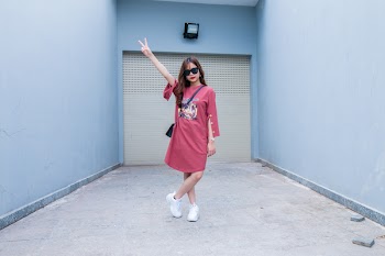 Woman Wearing Red Long-sleeved Dress Standing in Front of Shutter Door 