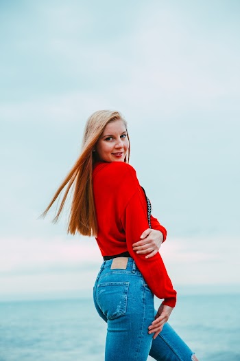 Woman Wearing Red Long-sleeved Shirt and Jeans Pants 