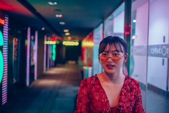 Woman Wearing Red Long-sleeved Top and Sunglasses on Hallway