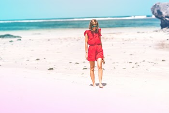 Woman Wearing Red Romper on Beach