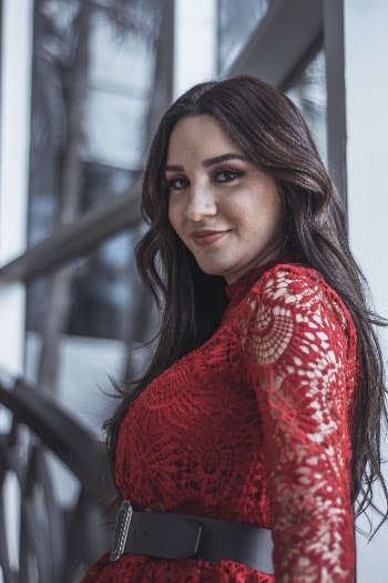 Woman Wearing Red See Through Long-sleeved Dress Smiling While Glancing Her Left Side