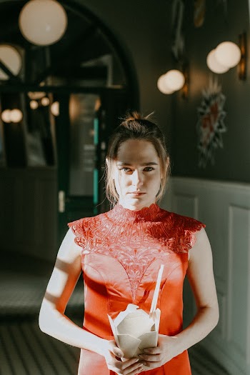 Woman Wearing Red Sleeveless Dress Holding White Paper