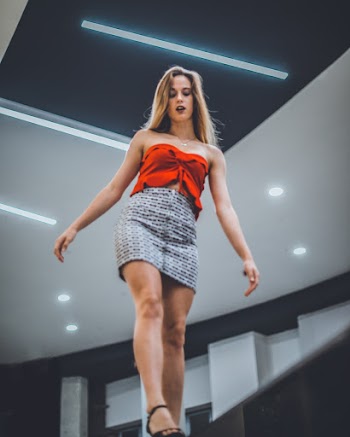 Woman Wearing Red Strapless Top And Grey Skirt