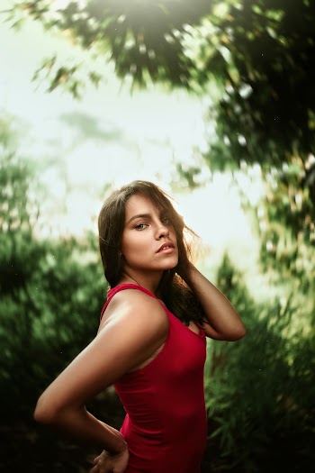 Woman Wearing Red Tank Top Standing With Right Arm Akimbo
