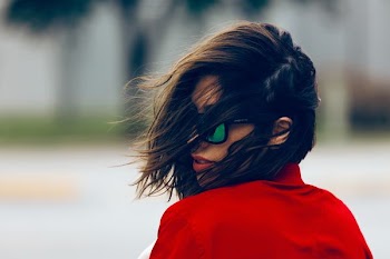woman wearing red top and black sunglasses at daytime