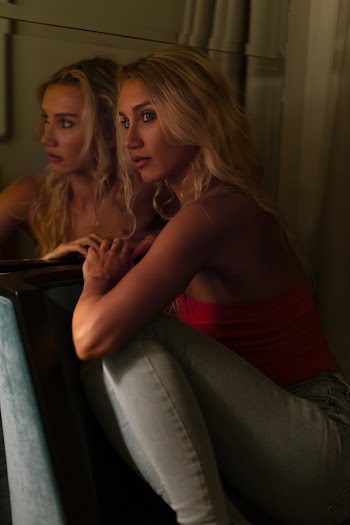 Woman Wearing Red Tube-top Sitting on Chair