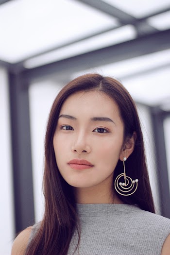 Woman Wearing Silver-colored Drop Earring