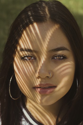 Woman Wearing Silver-colored Hoop Earrings
