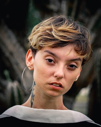 Woman Wearing Silver-colored Hoop Earrings