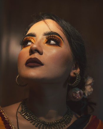 Woman Wearing Silver-colored Necklace and Earrings