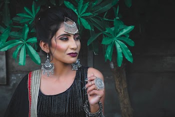 Woman Wearing Silver Coloured Earrings