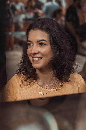 Woman Wearing Silver Necklace And Orange Crew Neck Shirt