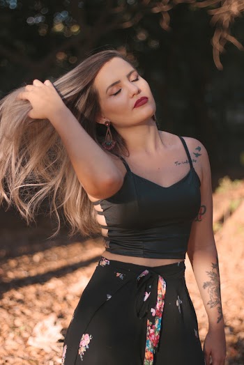 Woman Wearing Spaghetti Strap and Holding Her Hair