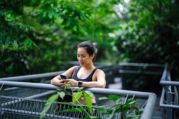 Woman Wearing Sports Bra Looking at Phone